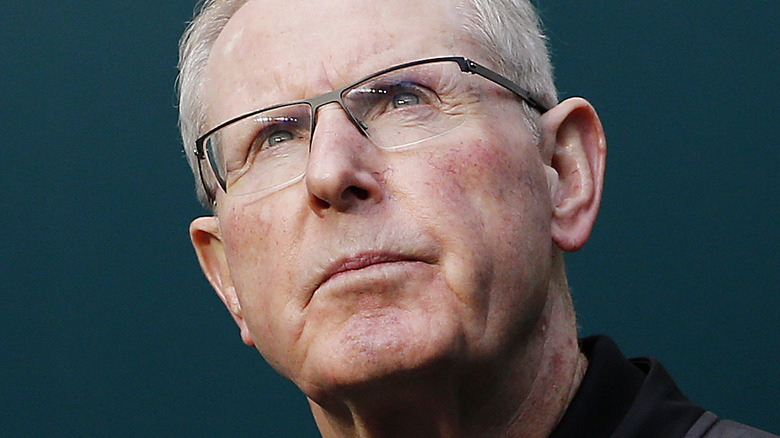 Tom Coughlin looking upwards wearing glasses