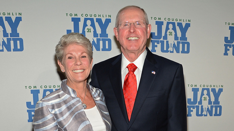 Tom Judy Coughlin smiling on red carpet