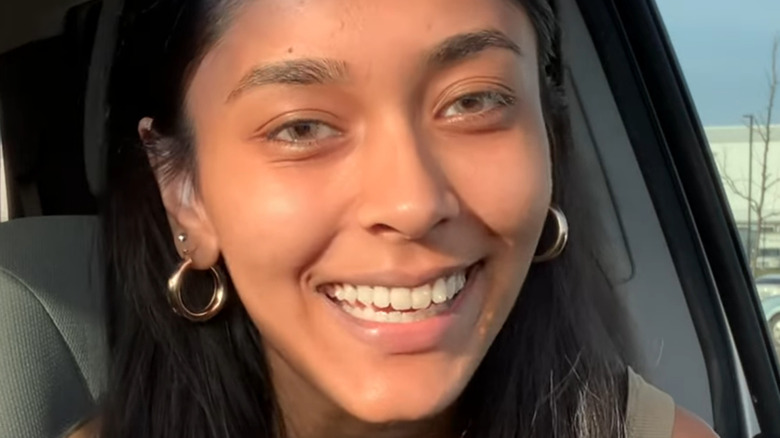 Megha Thakur smiles in a YouTube video