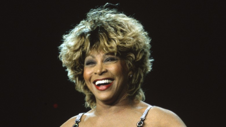 Tina Turner with wide smile on stage 