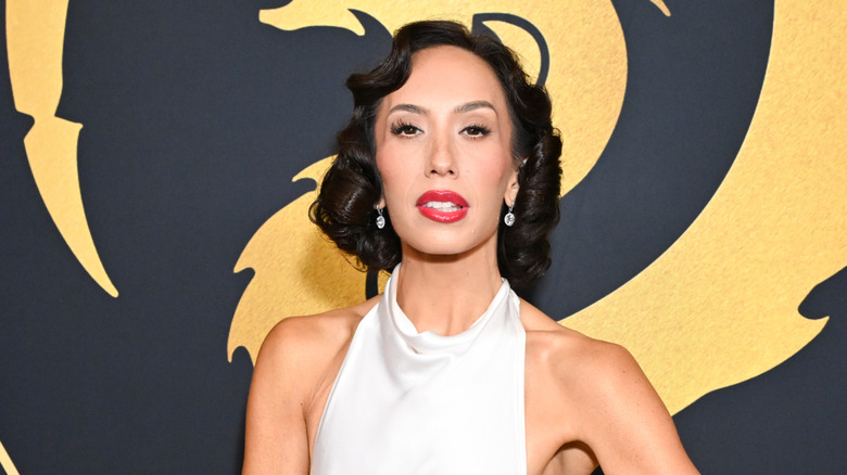 Cheryl Burke posing on a red carpet in 2025