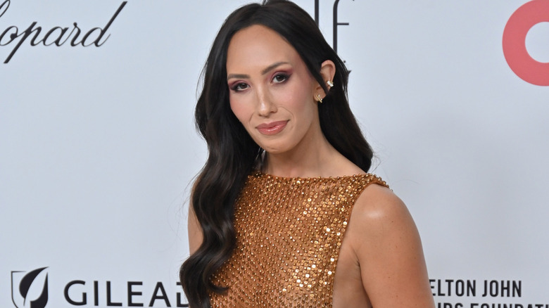 Cheryl Burke wearing a sparkling gold dress