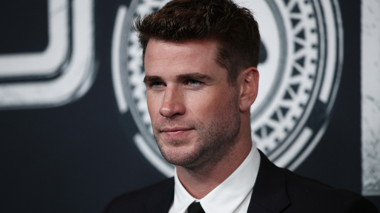 Liam Hemsworth serious at a red carpet event