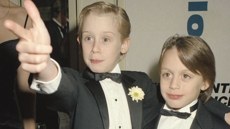 Macaulay Culkin and his brother, posing