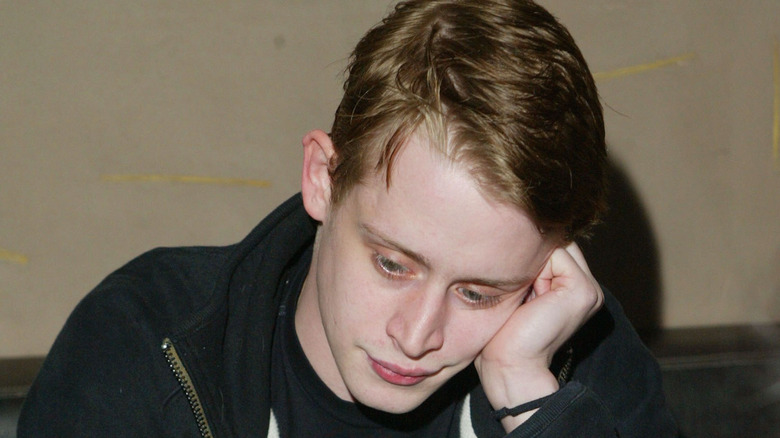 Macaulay Culkin looking pensive