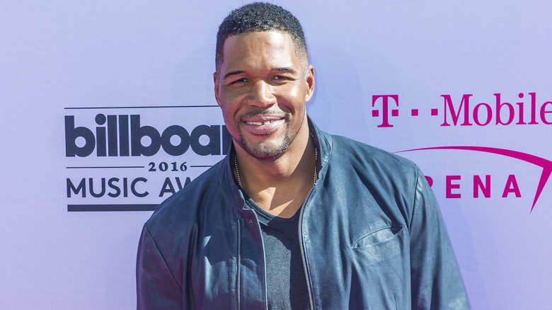 Michael Strahan on red carpet wearing leather jacket