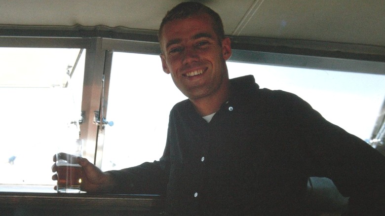 Fred Trump Jr. smiling on a boat, holding a glass of beer