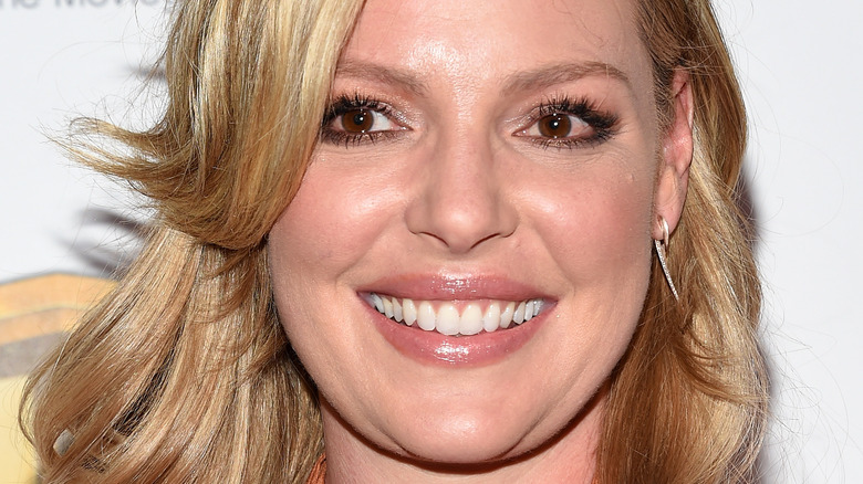 Katherine Heigl smiles in silver earring. 