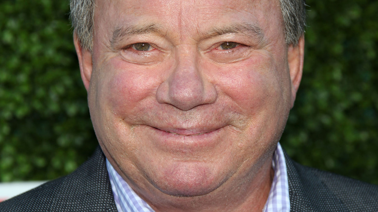 William Shatner smiles in a suit