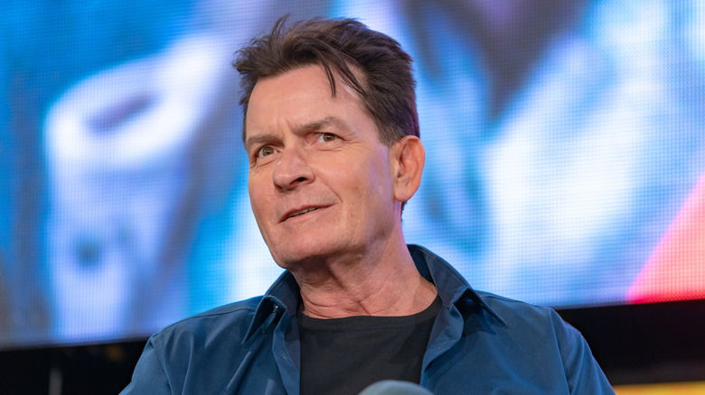 Charlie Sheen wearing a blue shirt