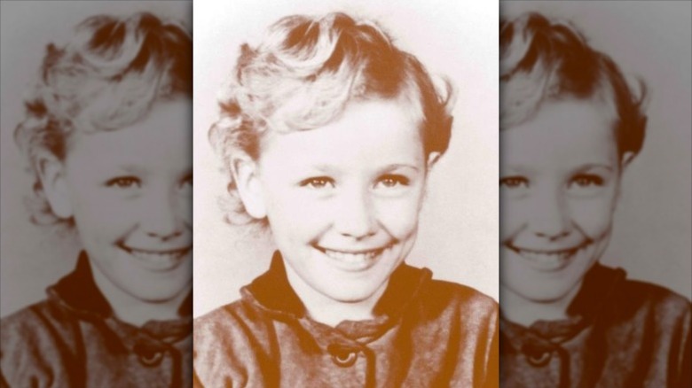 Dolly Parton smiles as a child
