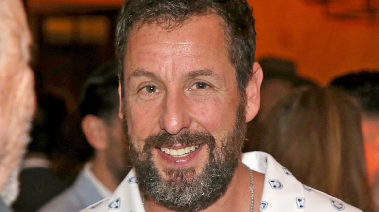 Adam Sandler smiling in 2022