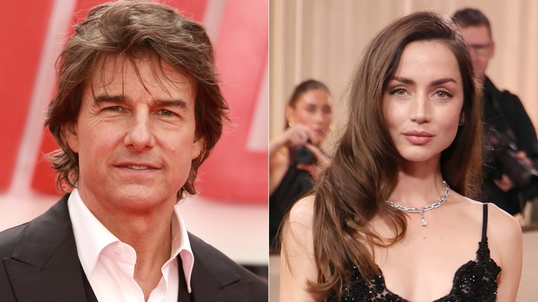 Tom Cruise wearing a black jacket and white collared shirt and Ana de Armas wearing a black sparkling gown