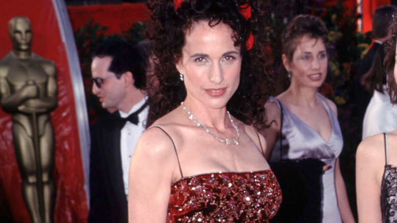 Andie MacDowell in long beaded dress with roses in hair