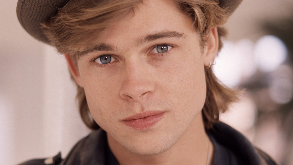 Headshot of Brad Pitt in a hat