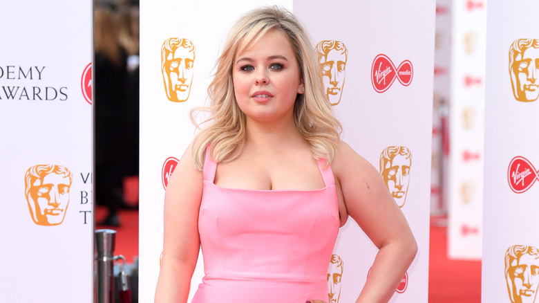 Nicola Coughlan wearing a pink dress on the red carpet of the BAFTAs