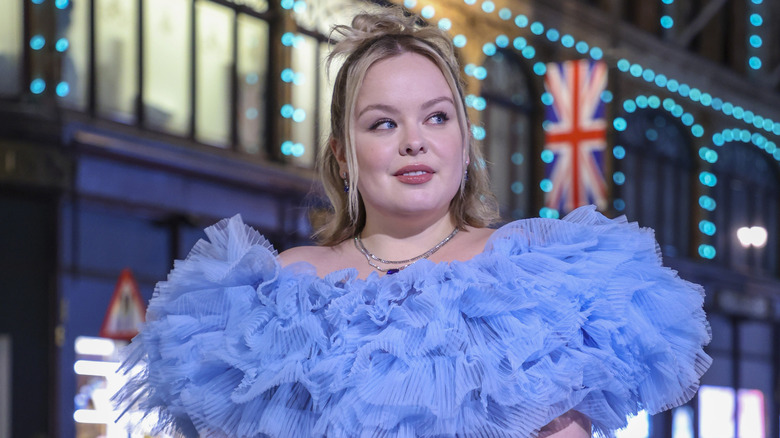 Nicola Coughlan posing outside Harrods wearing a blue dress