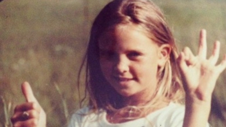 Charlize Theron gives thumbs up as a child