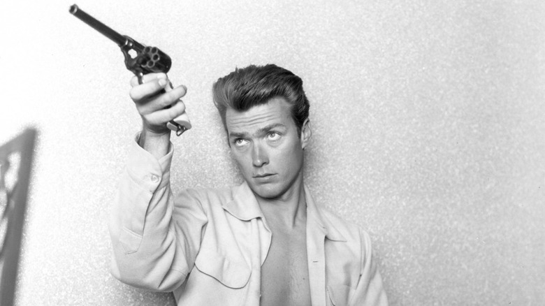 Clint Eastwood holding a pistol in 1956.