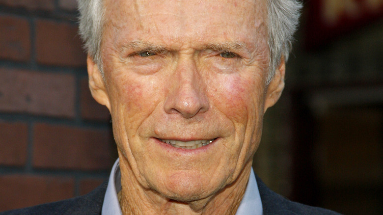 Clint Eastwood smiles in a suit.