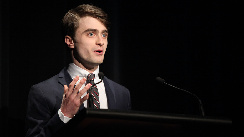 Daniel Radcliffe speaks on stage in 2011.