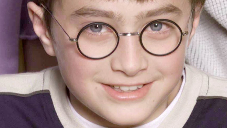 Daniel Radcliffe at age 11 wearing glasses and smiling