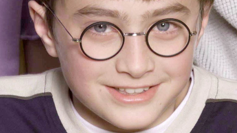 Daniel Radcliffe at age 11 wearing glasses and smiling