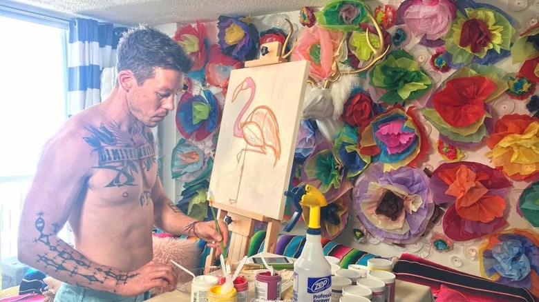 David Bromstad painting in his studio
