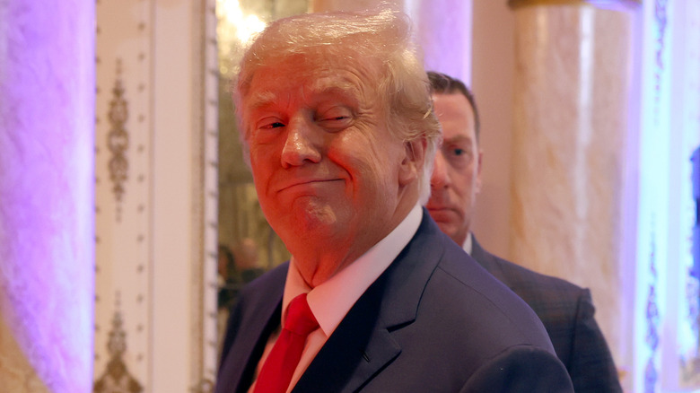Trump gives a smile to photographers on midterm night in 2022.