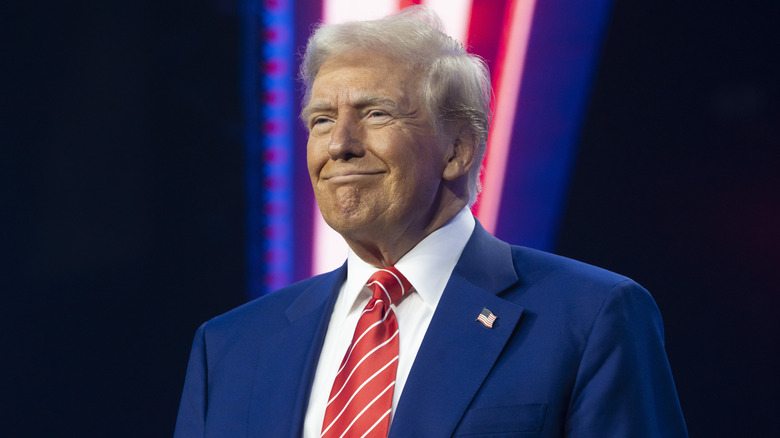 Donald Trump puckering his chin on stage in 2024.