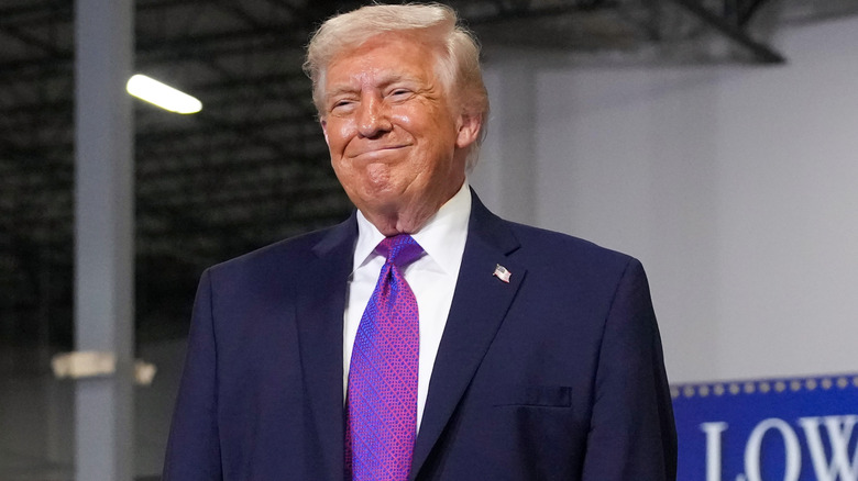 Donald Trump gives a chin-puckering smile to an audience in Kentucky.