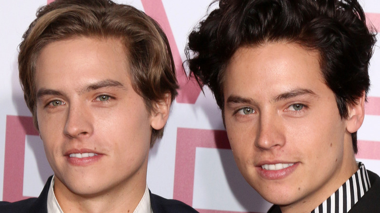 Dylan and Cole Sprouse look on