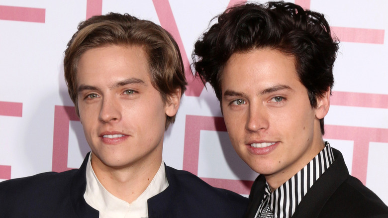 Dylan and Cole Sprouse look on