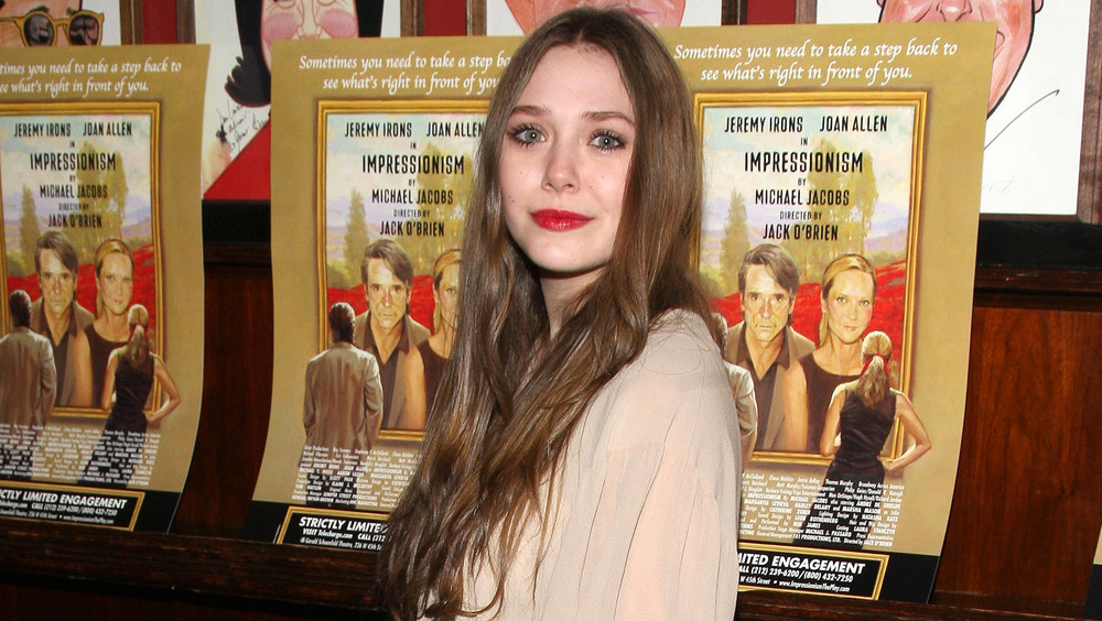 Elizabeth Olsen smiling on the red carpet for Impressionism