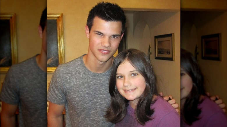 Taylor Lautner posing with Ella Bleu Travolta