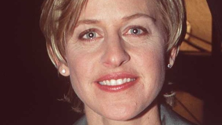 Ellen DeGeneres poses in a lavender suit in 1996