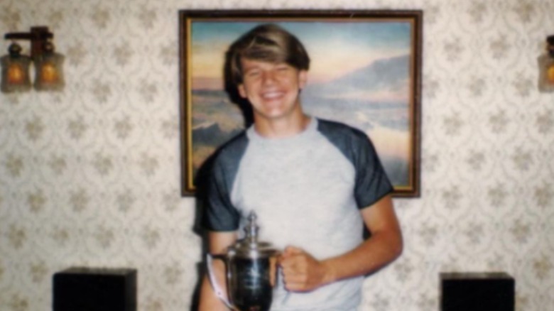 Gordon Ramsay posing with a trophy as a teen