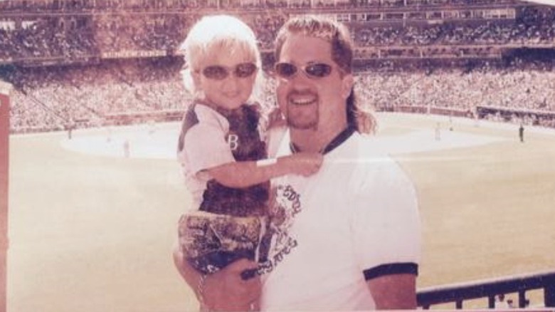 Guy Fieri holding son at stadium