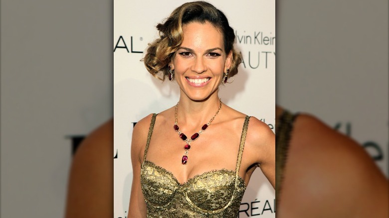 Hilary Swank wearing gold Calvin Klein dress