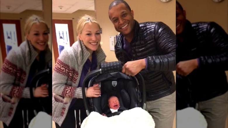 Lindsay Czarniak and husband Craig Melvin pose with their newborn son