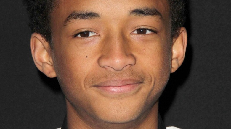 A closeup of a teenage Jaden Smith, smiling