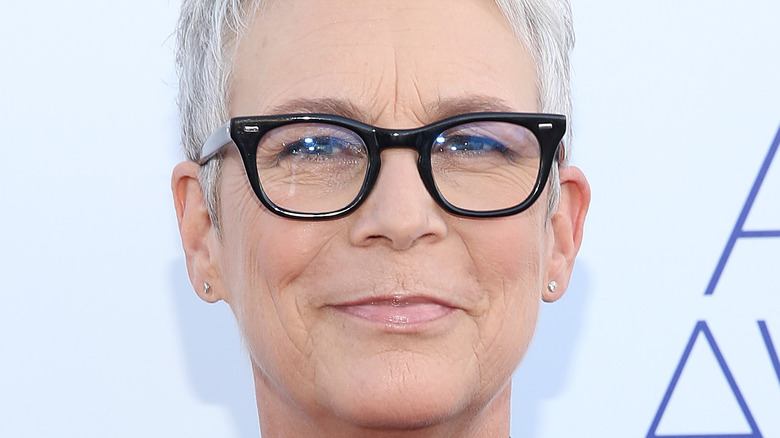 Jamie Lee Curtis posing in black-framed glasses