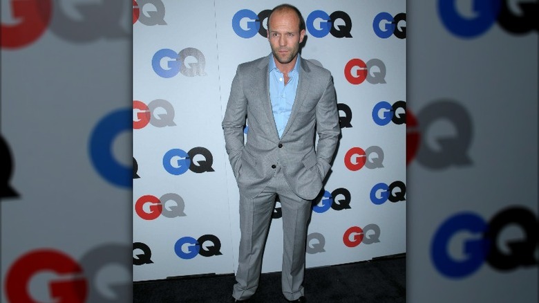 Jason Statham in grey suit with a light blue shirt
