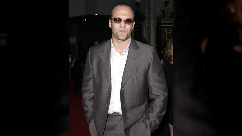 Jason Statham in a grey suit and shades