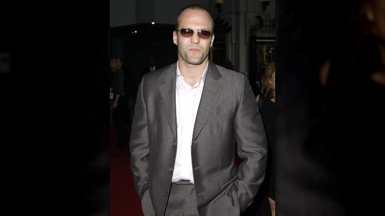 Jason Statham in a grey suit and shades