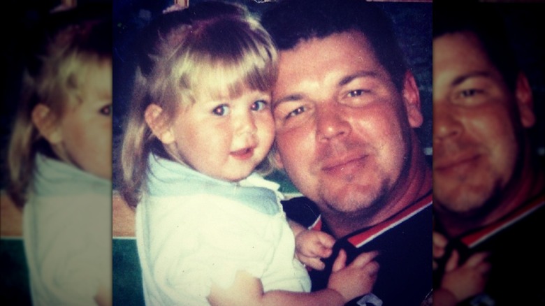 Young Karoline Leavitt grab the shirt of her dad, Bob Leavitt, as their faces touch.
