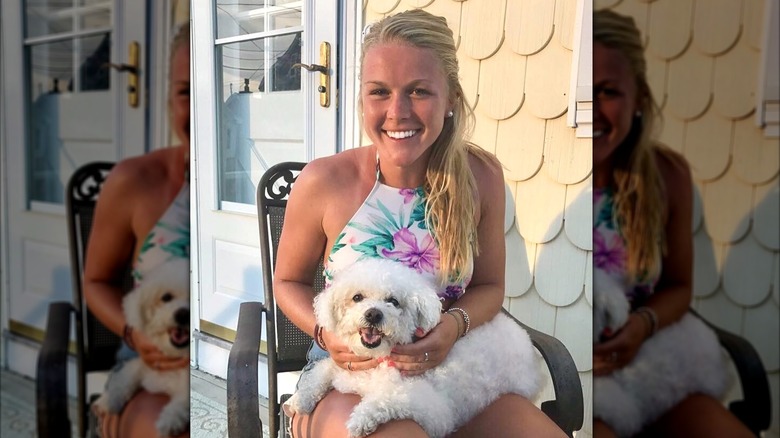Karoline Leavitt is all smiles as a white puppy sits on her lap.