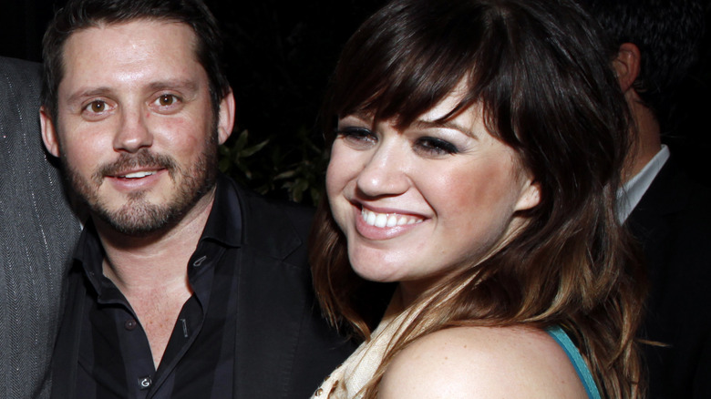 Kelly Clarkson and Brandon Blackstock smiling together in 2012