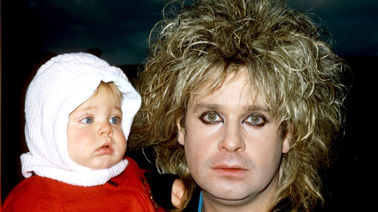 Baby Kelly Osbourne and Ozzy Osbourne posing for photo