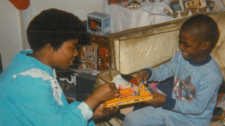 Nancy Hart and Kevin Hart playing with a toy